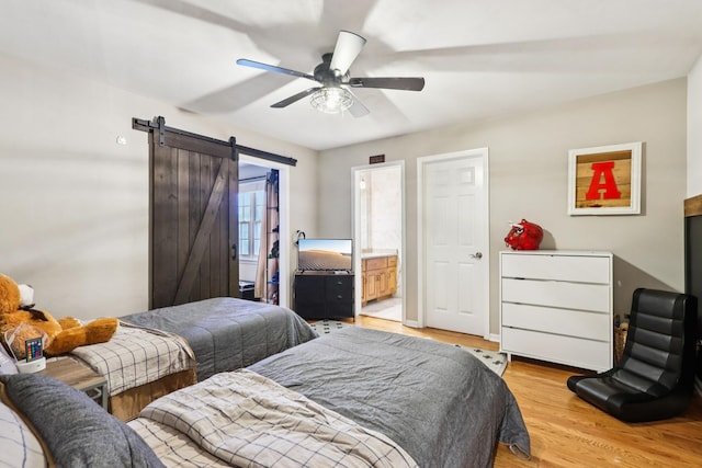 51 Mitchell Cir, Wheaton, IL 60189 - bedroom with a barn door, light wood-style flooring, ensuite bathroom, and ceiling fan