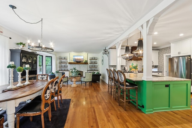 51 Mitchell Cir, Wheaton, IL 60189 - dining room with a chandelier, a fireplace, light wood-style floors, and recessed lighting