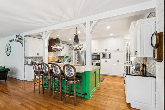 51 Mitchell Cir, Wheaton, IL 60189 - kitchen with appliances with stainless steel finishes, a kitchen island with sink, backsplash, white cabinets, and recessed lighting