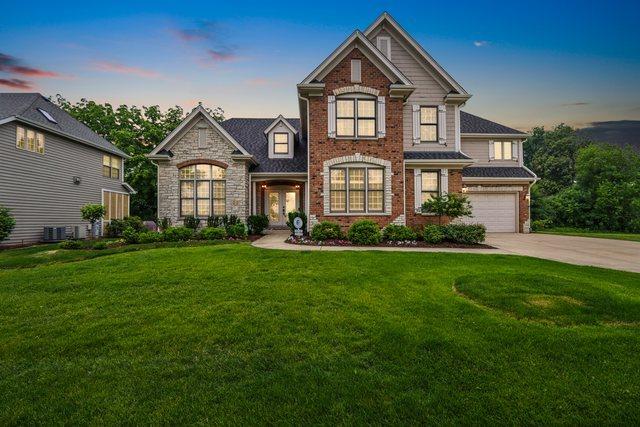 51 Mitchell Cir, Wheaton, IL 60189 - view of front facade with driveway, french doors, a garage, and a yard