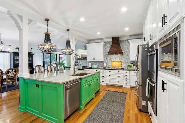 51 Mitchell Cir, Wheaton, IL 60189 - kitchen with appliances with stainless steel finishes, white cabinets, premium range hood, a center island with sink, and decorative backsplash