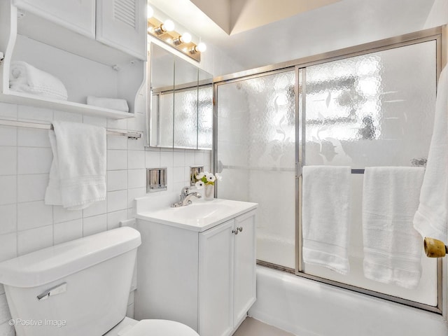 4220 Maple Ave, Brookfield, IL 60513 - full bathroom featuring vanity, bath / shower combo with glass door, decorative backsplash, and tile walls