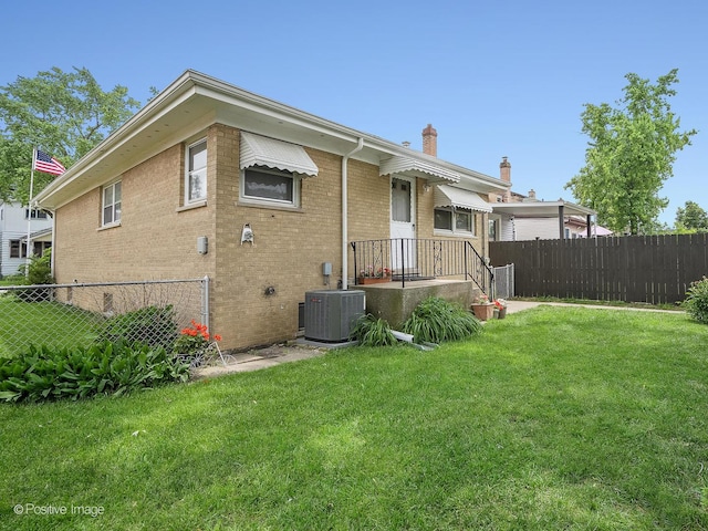 4220 Maple Ave, Brookfield, IL 60513 - back of house with a chimney and brick siding