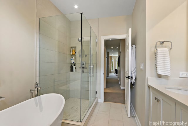 358 W Huron St Unit B, Chicago, IL 60654 - bathroom with a freestanding bath, a shower stall, vanity, tile patterned flooring, and recessed lighting