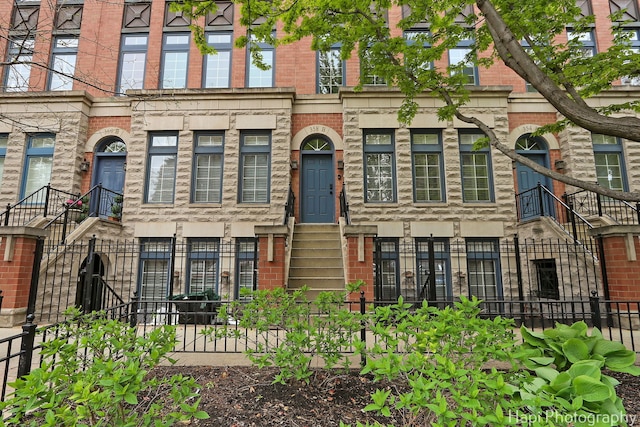 358 W Huron St Unit B, Chicago, IL 60654 - multi unit property with a fenced front yard, entry steps, and brick siding