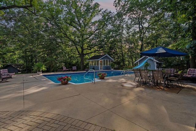13302 Archer Ave, Lemont, IL 60439 - swimming pool featuring a water slide, an outdoor structure, a patio area, an exterior structure, and view of wooded area