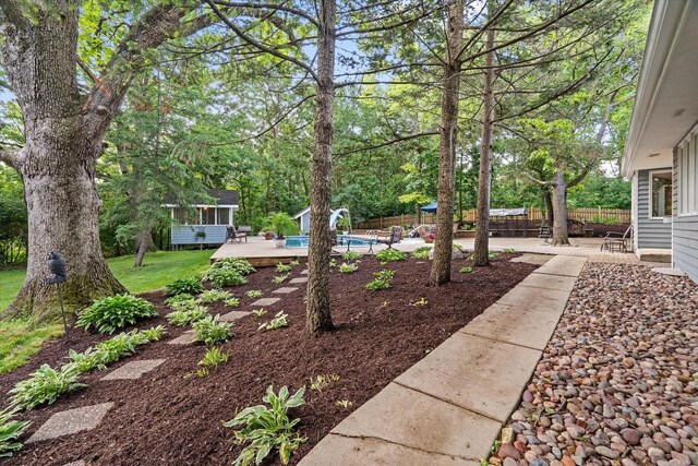 13302 Archer Ave, Lemont, IL 60439 - fenced backyard with a wooden deck, a patio, and view of scattered trees