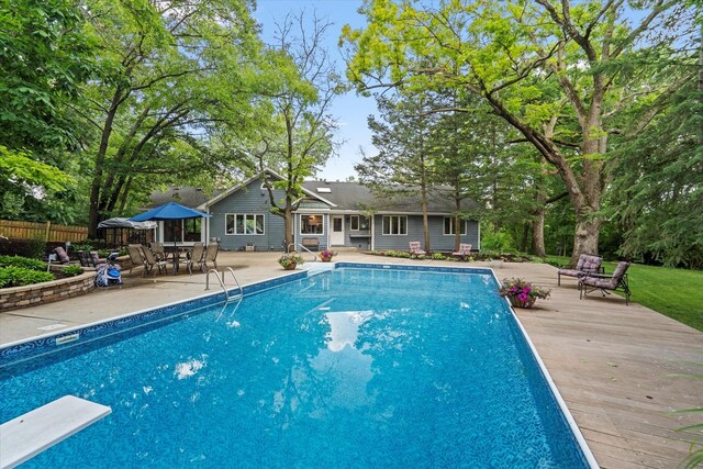 13302 Archer Ave, Lemont, IL 60439 - outdoor pool featuring a deck, a diving board, a patio, and outdoor dining space