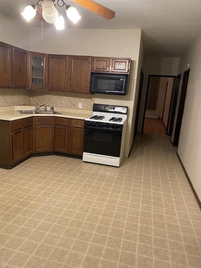 5015 S Talman Ave, Chicago, IL 60632 - kitchen featuring black microwave, white range with gas stovetop, light countertops, tasteful backsplash, and glass insert cabinets