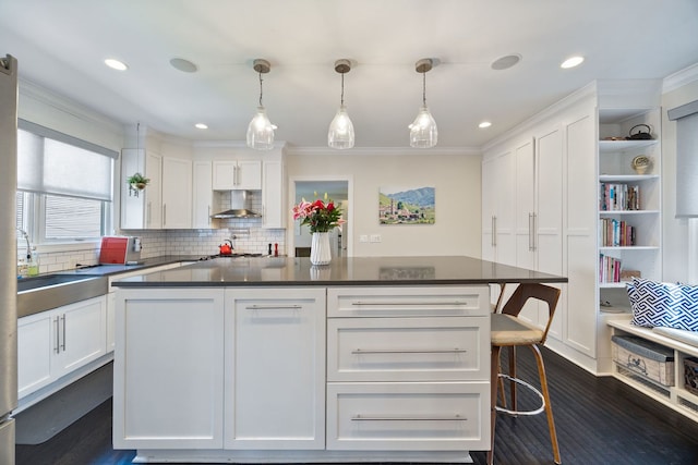 2012 W Charleston St, Chicago, IL 60647 - kitchen with wall chimney exhaust hood, white cabinetry, dark countertops, crown molding, and recessed lighting