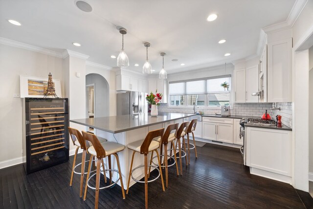 2012 W Charleston St, Chicago, IL 60647 - kitchen with dark countertops, stainless steel fridge, arched walkways, beverage cooler, and backsplash