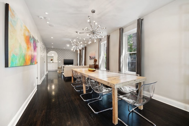 2012 W Charleston St, Chicago, IL 60647 - dining area with a chandelier, wood finished floors, wallpapered walls, and arched walkways
