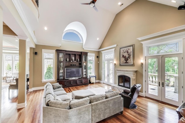 2940 Farner Ct, Riverwoods, IL 60015 - living room with french doors, high vaulted ceiling, a ceiling fan, light wood-style floors, and a glass covered fireplace