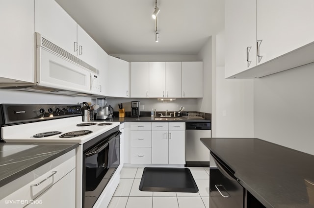 100 E Walton St Unit 40A, Chicago, IL 60611 - kitchen featuring range with electric stovetop, white microwave, dishwasher, dark countertops, and light tile patterned floors