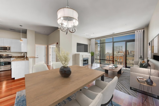 520 S State St Unit 1726, Chicago, IL 60605 - dining room with a premium fireplace, wood finished floors, and a chandelier