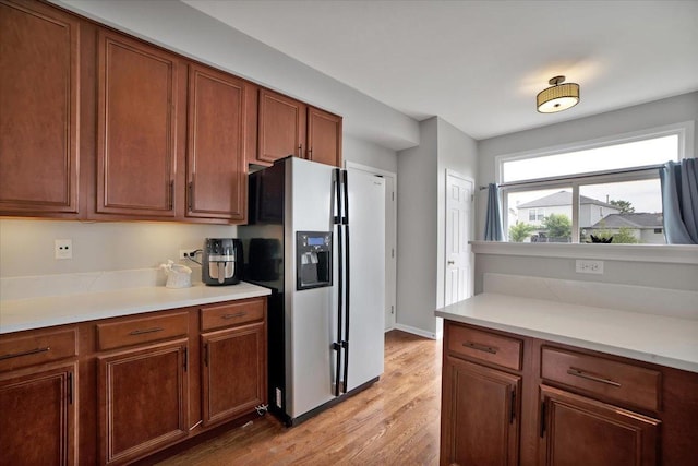 1854 Westridge Pl, Aurora, IL 60504 - kitchen with stainless steel fridge, light wood-style flooring, light countertops, and brown cabinets