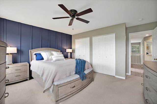 1854 Westridge Pl, Aurora, IL 60504 - bedroom with light carpet, two closets, a ceiling fan, and a decorative wall