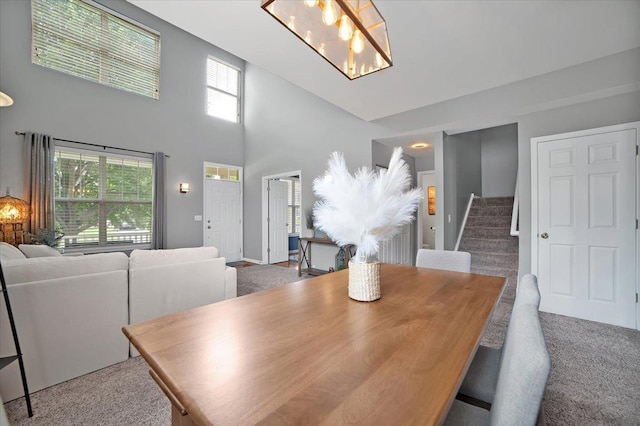 1854 Westridge Pl, Aurora, IL 60504 - carpeted dining space with stairway, a chandelier, and a high ceiling