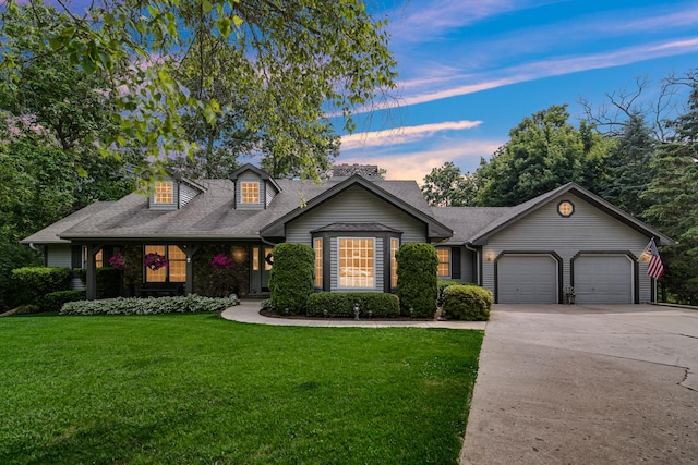 25115 W Cedarwood Ln, Ingleside, IL 60041 - view of front of home with an attached garage, a yard, concrete driveway, and roof with shingles