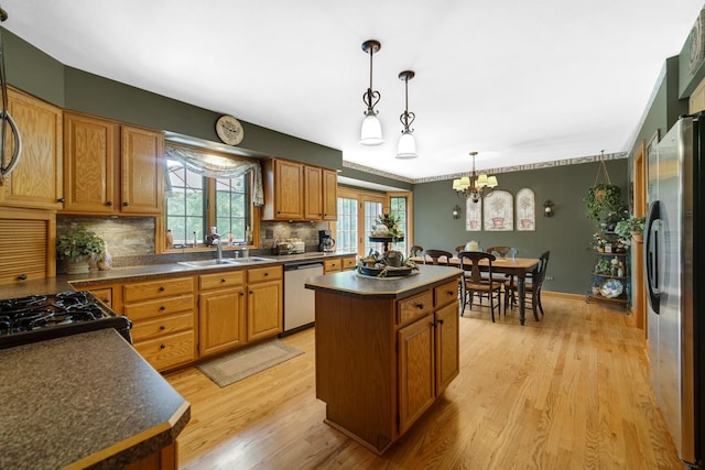 25115 W Cedarwood Ln, Ingleside, IL 60041 - kitchen with appliances with stainless steel finishes, dark countertops, a kitchen island, backsplash, and light wood-style flooring