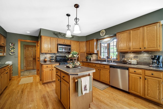 25115 W Cedarwood Ln, Ingleside, IL 60041 - kitchen with appliances with stainless steel finishes, dark countertops, and light wood-type flooring