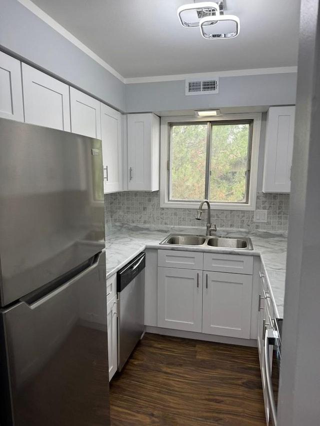 5204 Midlothian Tpke Unit 222, Crestwood, IL 60418 - kitchen with stainless steel appliances, backsplash, white cabinetry, dark wood-type flooring, and ornamental molding