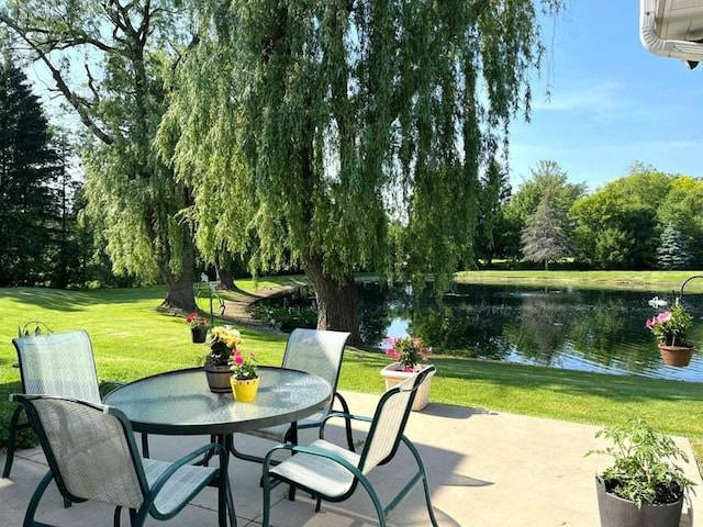 W4782 Potter Rd Unit 2, Elkhorn, WI 53121 - view of patio / terrace with a water view, view of wooded area, and outdoor dining area