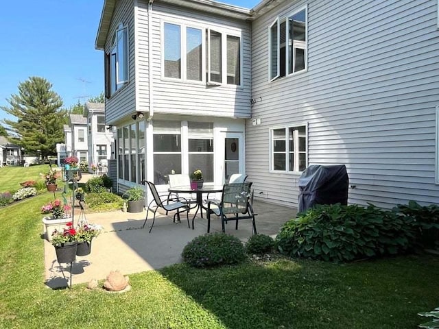 W4782 Potter Rd Unit 2, Elkhorn, WI 53121 - rear view of property featuring a patio, a lawn, and a sunroom