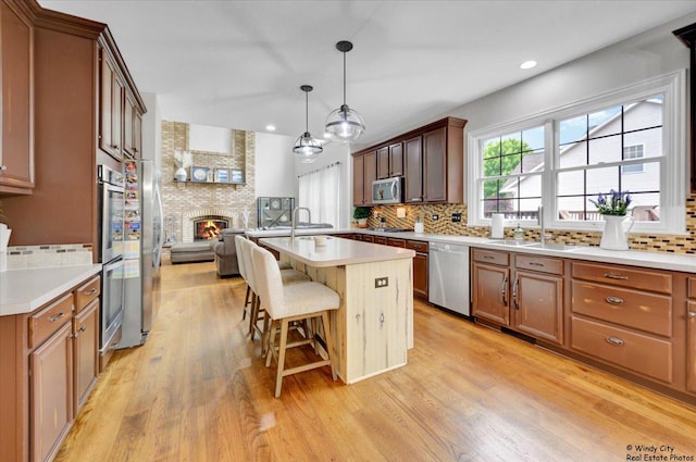 1880 Crofton Dr, Algonquin, IL 60102 - kitchen featuring stainless steel appliances, backsplash, a breakfast bar area, light wood finished floors, and open floor plan
