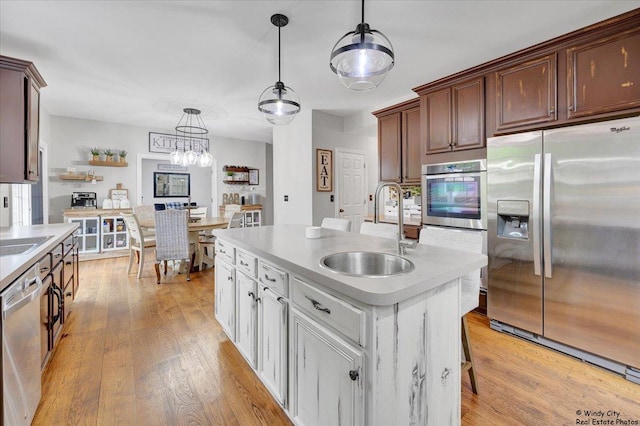 1880 Crofton Dr, Algonquin, IL 60102 - kitchen featuring stainless steel appliances, light countertops, light wood-style floors, and hanging light fixtures