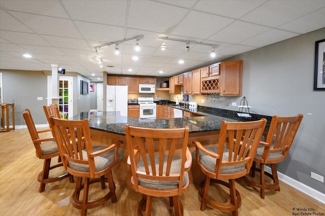 1880 Crofton Dr, Algonquin, IL 60102 - kitchen with white appliances, track lighting, light wood finished floors, a peninsula, and a kitchen breakfast bar