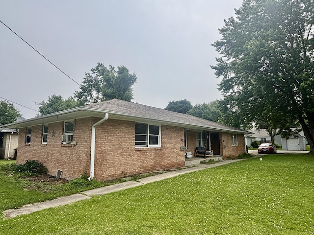 328 W Harrison St, Belvidere, IL 61008 - back of property with a yard, brick siding, covered porch, and cooling unit