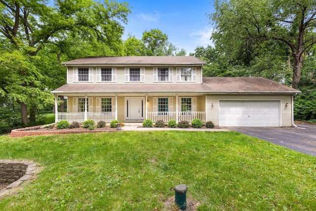 7204 Warblers Way, Roscoe, IL 61073 - colonial-style house with asphalt driveway, a garage, covered porch, and a front yard