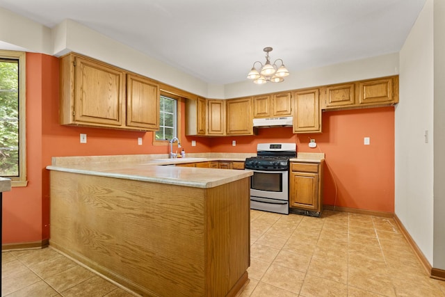 7204 Warblers Way, Roscoe, IL 61073 - kitchen featuring gas range, under cabinet range hood, a peninsula, light countertops, and a chandelier