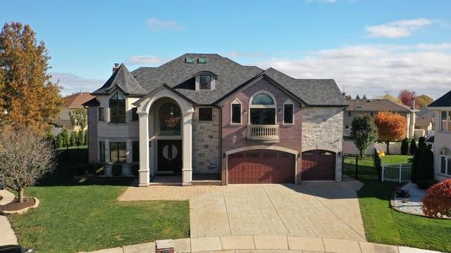 7818 Braeloch Ct, Orland Park, IL 60462 - french country style house featuring an attached garage, driveway, and a balcony