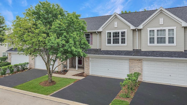 1335 Acorn Dr, Crest Hill, IL 60403 - view of front of home featuring brick siding, a shingled roof, and driveway