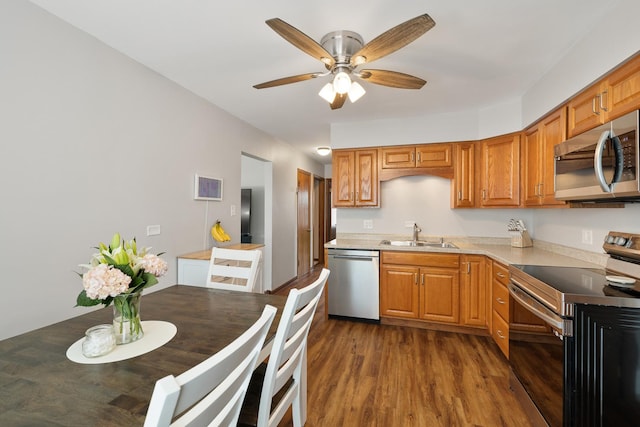 10843 Mcvicker Ave, Chicago Ridge, IL 60415 - kitchen with stainless steel appliances, dark wood finished floors, a ceiling fan, light countertops, and brown cabinets