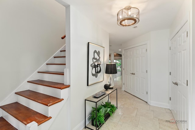 1819 Farm Rd, Lake Forest, IL 60045 - foyer featuring stairs, a chandelier, and stone tile flooring