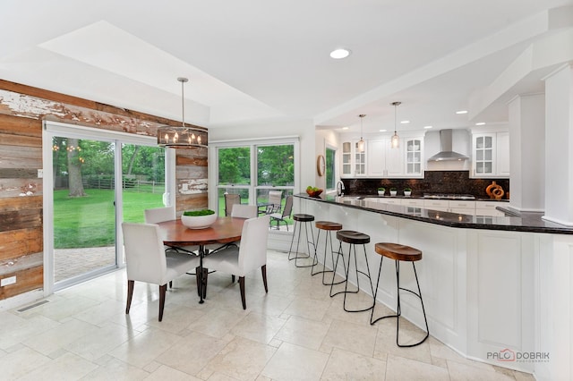 1819 Farm Rd, Lake Forest, IL 60045 - kitchen with wall chimney range hood, tasteful backsplash, stainless steel gas stovetop, white cabinetry, and recessed lighting