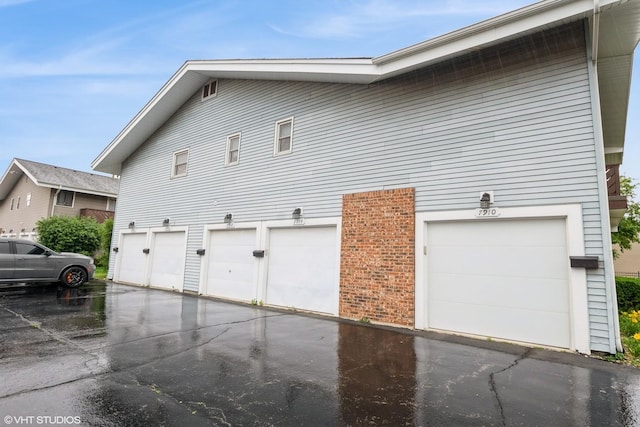 7914 164th Ct Unit 0, Tinley Park, IL 60477 - view of property exterior featuring an attached garage and asphalt driveway