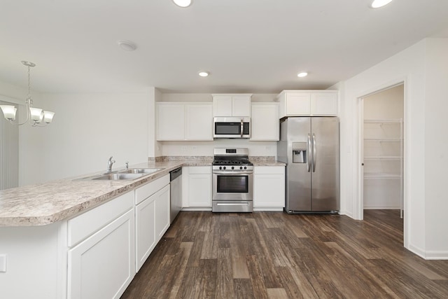 170 Goldenrod Dr, Elgin, IL 60124 - kitchen with appliances with stainless steel finishes, light countertops, dark wood-style floors, a peninsula, and white cabinets