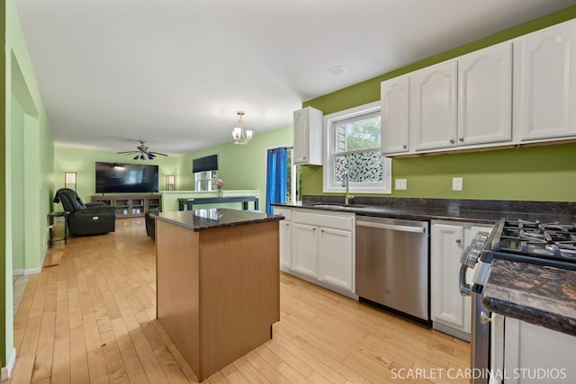 3100 Compton Rd, Aurora, IL 60504 - kitchen featuring appliances with stainless steel finishes, a center island, white cabinets, open floor plan, and a ceiling fan