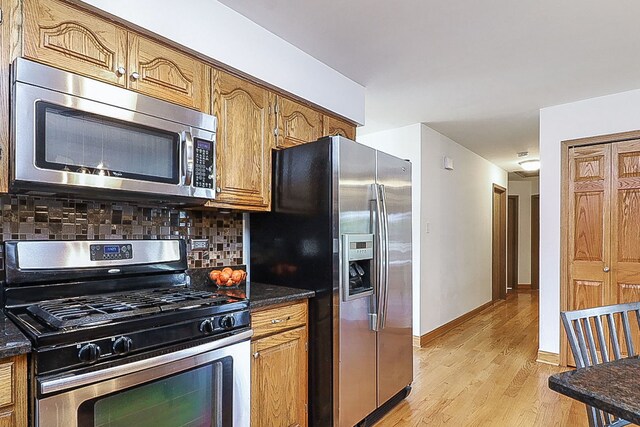 5135 W 113th Pl, Alsip, IL 60803 - kitchen with stainless steel appliances, light wood-style flooring, decorative backsplash, and brown cabinets