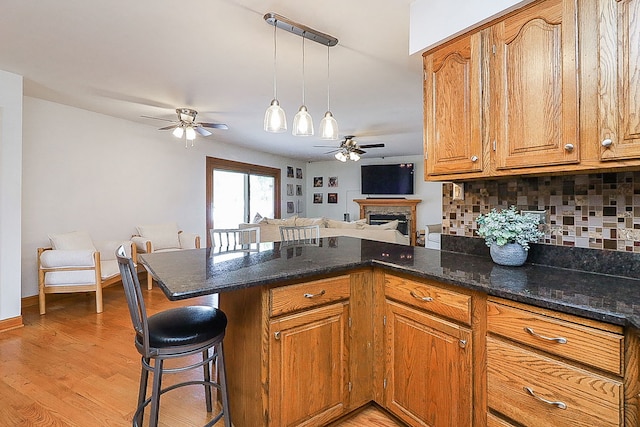 5135 W 113th Pl, Alsip, IL 60803 - kitchen featuring ceiling fan, a peninsula, backsplash, and brown cabinets