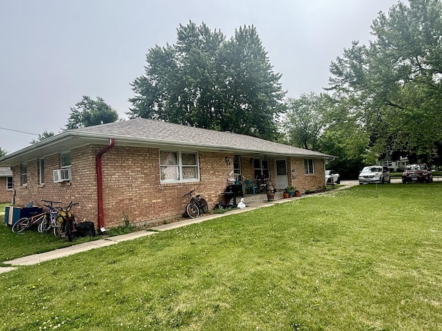 1027 Strawberry Ln, Belvidere, IL 61008 - view of front of house with a front lawn, brick siding, a porch, and cooling unit