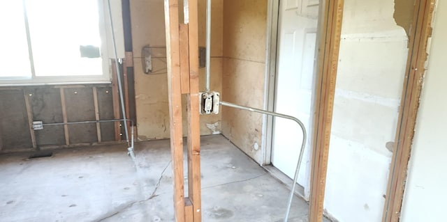 misc room with unfinished concrete floors