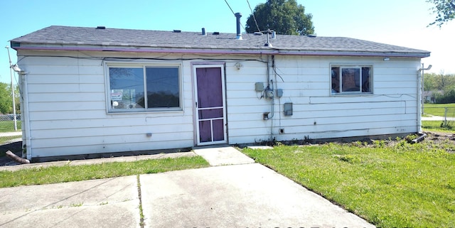 back of property with a lawn and a patio