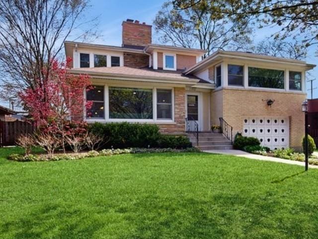 1712 Dobson St, Evanston, IL 60202 - view of front of home featuring a garage, a chimney, and brick siding
