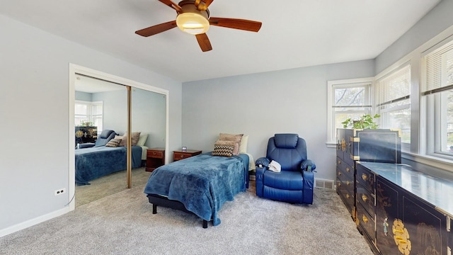 1712 Dobson St, Evanston, IL 60202 - carpeted bedroom featuring multiple windows, a closet, and ceiling fan