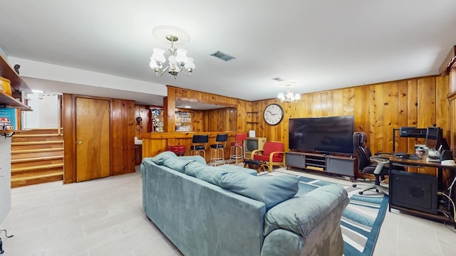 1712 Dobson St, Evanston, IL 60202 - living room featuring a chandelier, wood walls, stairs, and light tile patterned floors